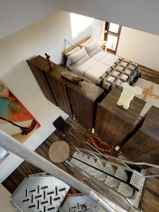 Interior view of Zero Cottage from the second set of metal stairs looking down to the third and second floor.