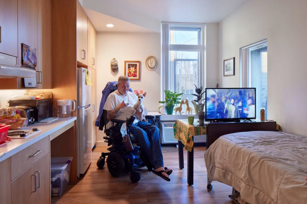 Resident inside his unit in Tahanan Supportive Housing in San Francisco.