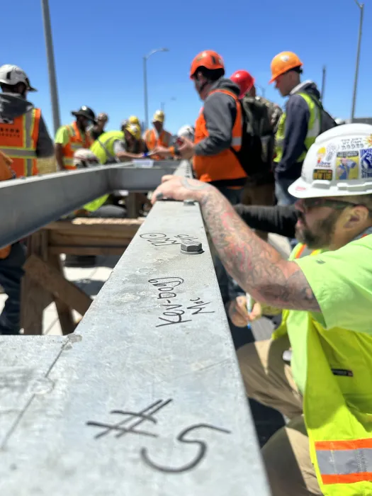 Construction crew signing the final beam at Tidal House SF.