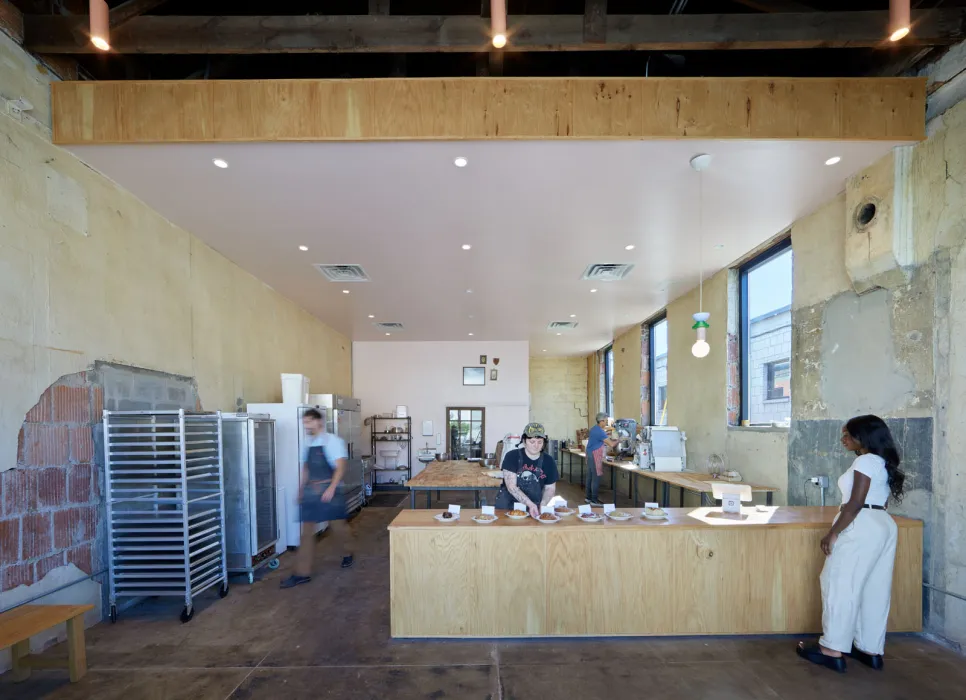 Interior of Last Call Bakery with someone standing a the counter at the Bandsaw Building in Birmingham, Alabama.