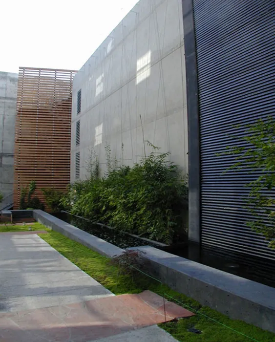 Entry courtyard with fountain wall and greenery at 1500 Park Avenue Lofts in Emeryville, California.