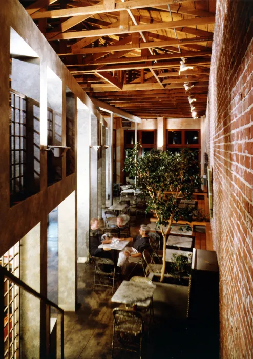 Interior view of Cafe Milano from the second level with four men having coffee in Berkeley, California.