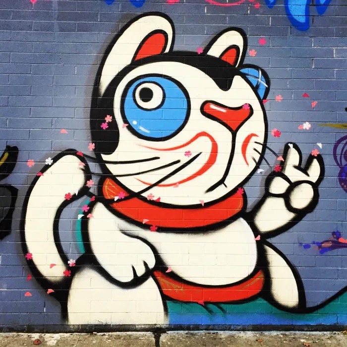 Detail of street art of a Japanese lucky cat on David Baker Architects office in Oakland.