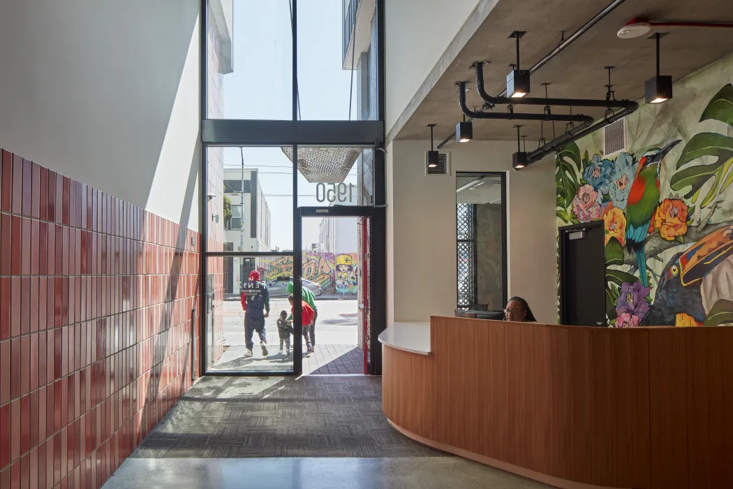 Interior lobby of La Fenix with a ceramic tile wall.