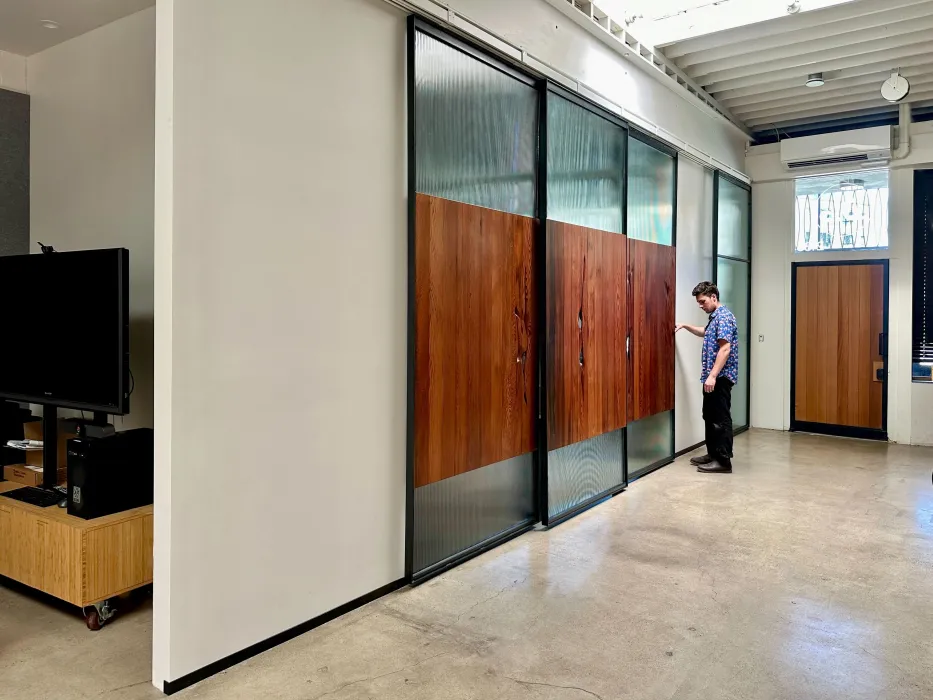 DBA_OAK sliding doors separating the conference room.