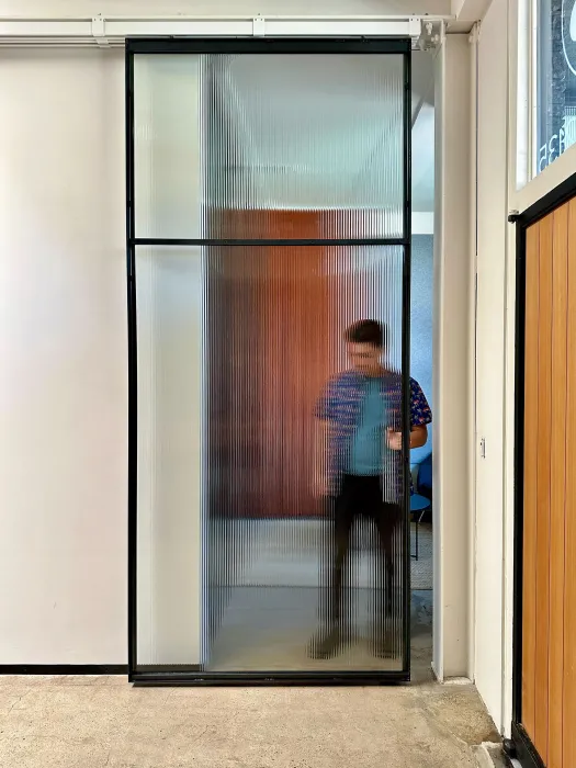DBA_OAK sliding doors separating the storefront lounge.