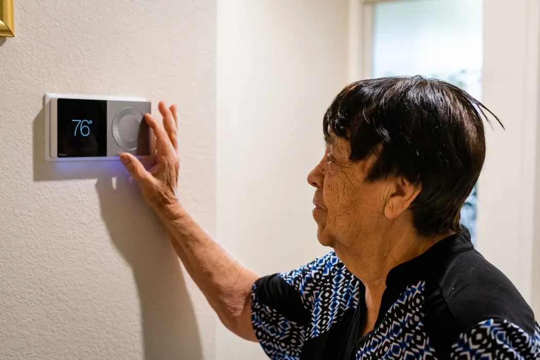 Resident using their thermostat at Vera Cruz Village in Richgrove, California.