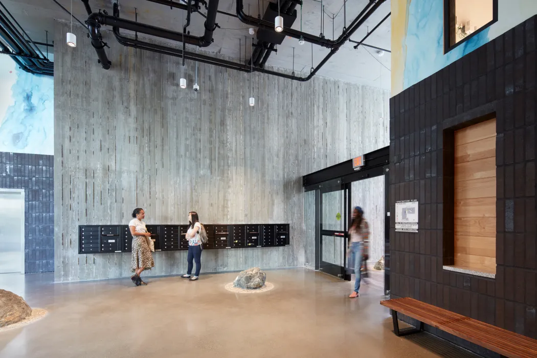 Textured concrete wall inside the 222 Taylor Street lobby.