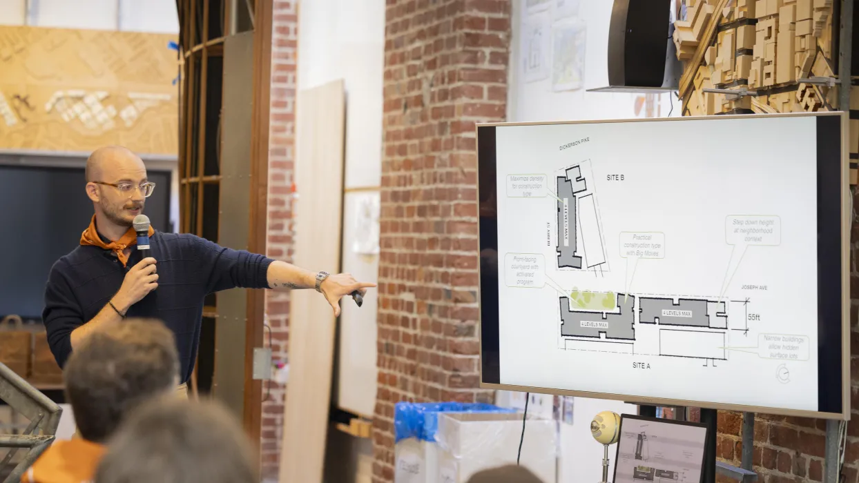 Man at the DBA SF Office presenting his project for the design roundup.