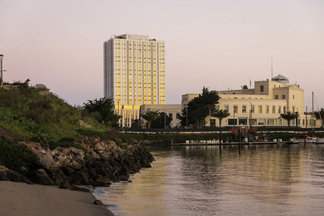 Exterior view of Isle House from the water at sunset.