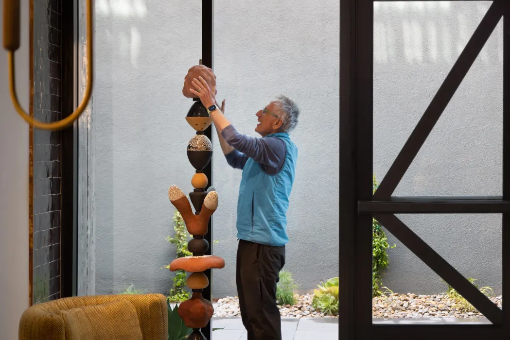 Man assembling a sculpture.