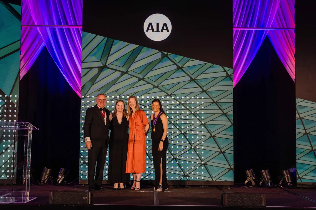 four people posing at the AIA conference.