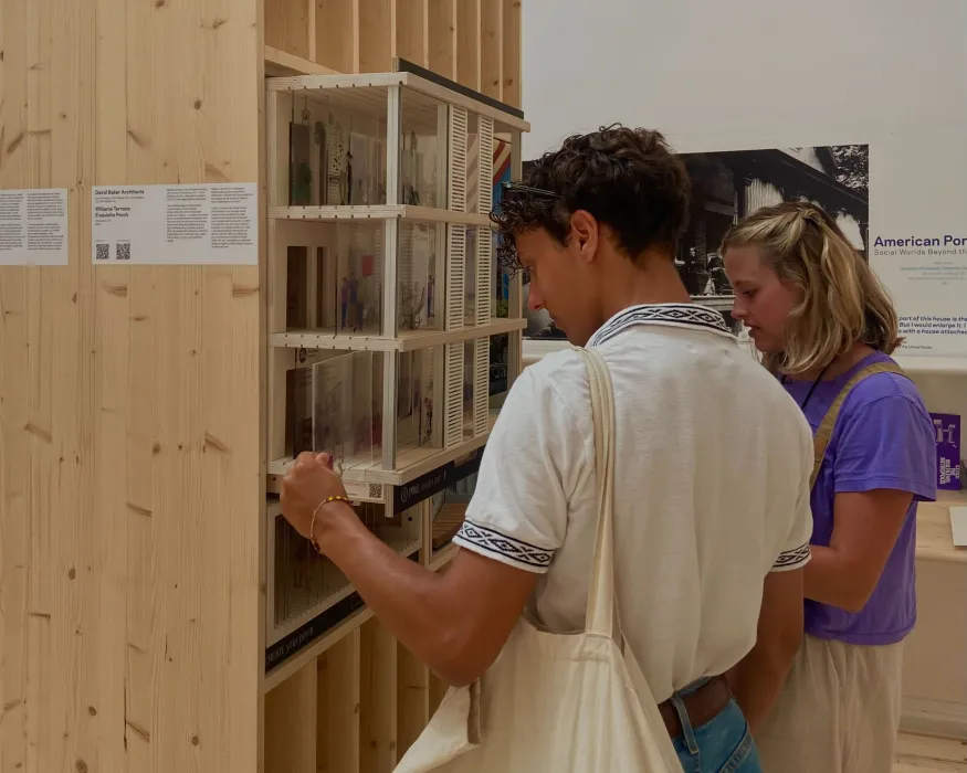 Closeup view of two people side by side interacting with diorama