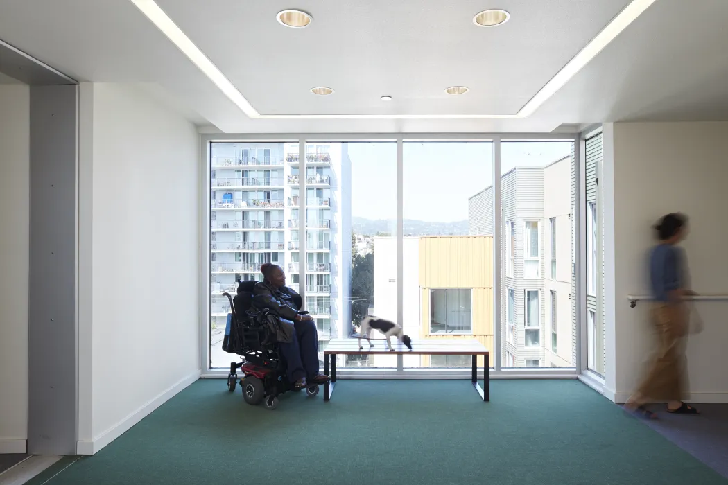 Wide corridor with bulb out that features seating and a big window