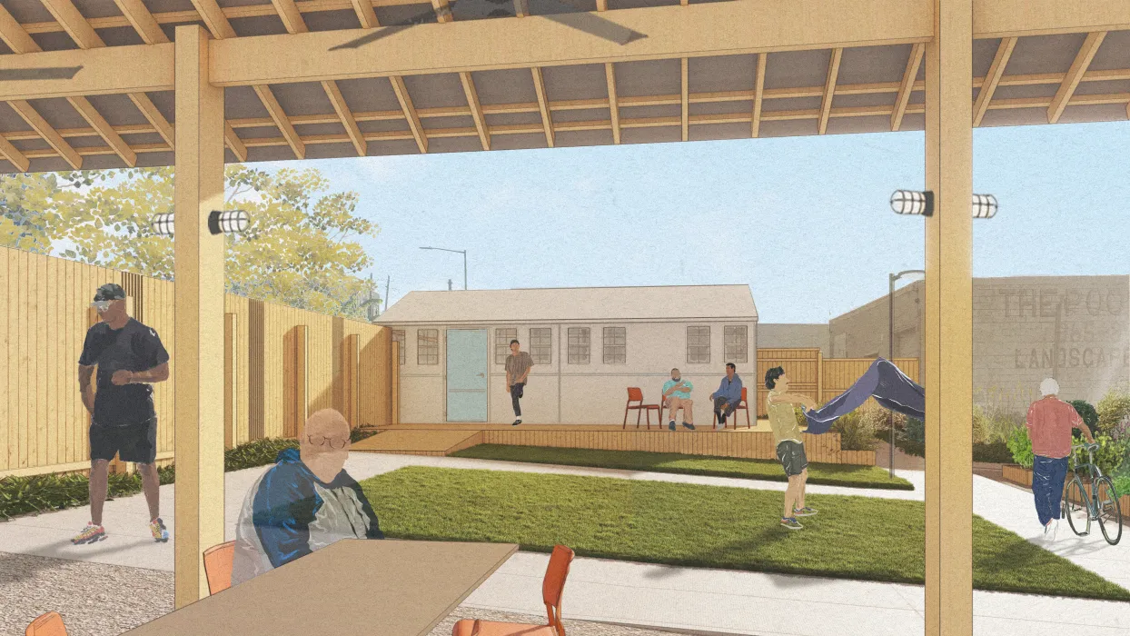 Man sitting under pavilion shelter with grass and small building in background
