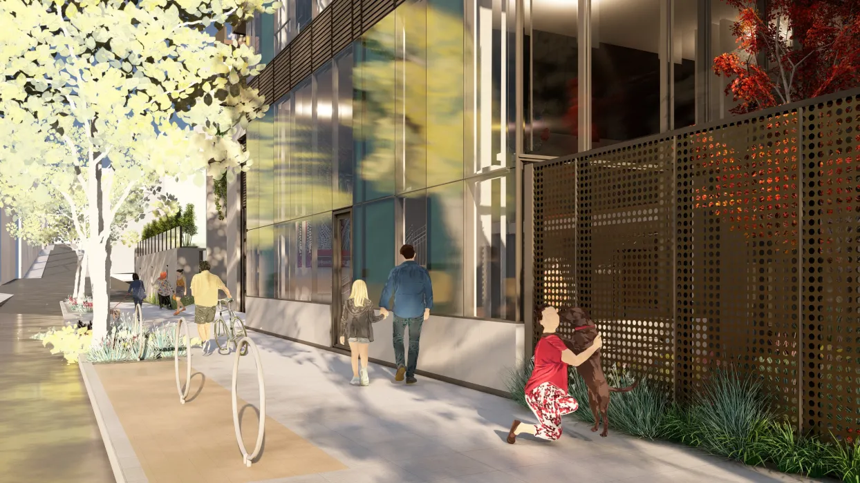 Girl with dog on sidewalk with screen and building in the background