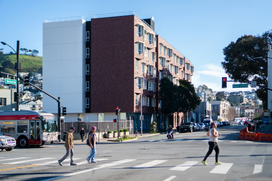 Apartment building in neighborhood context with pedestrians