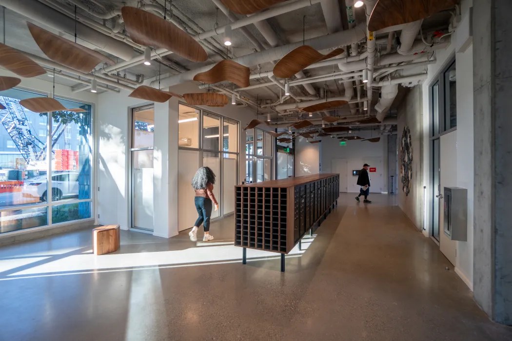 Wood ceiling tiles create interest in common area