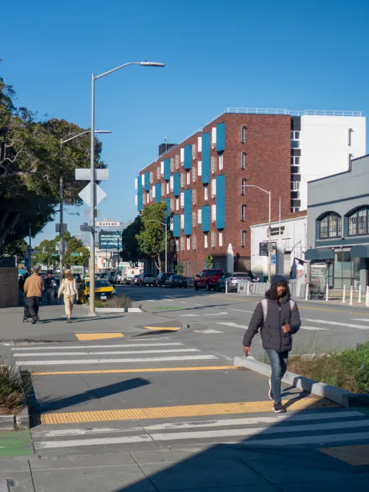 Apartment building in neighborhood context with pedestrians