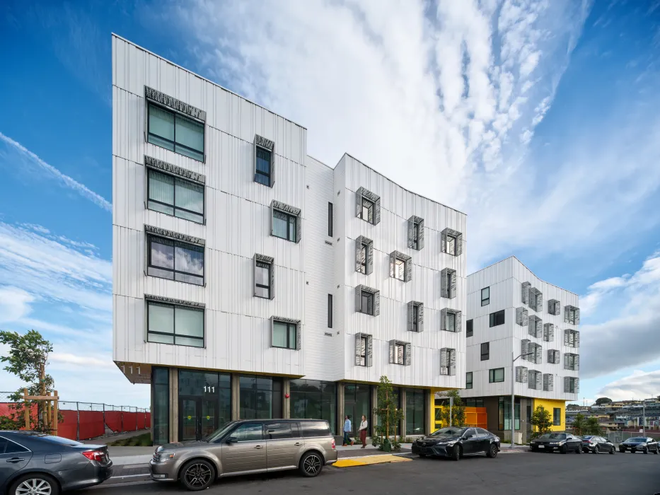 Street view of apartment building against blue sky