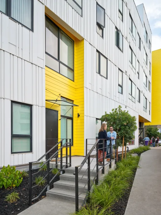 Two people chatting on a stoop 