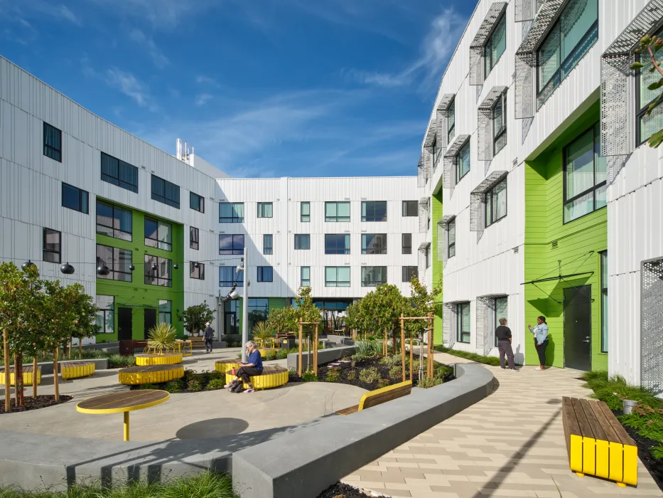 Overall view shows white volumes and glass volume in foreground