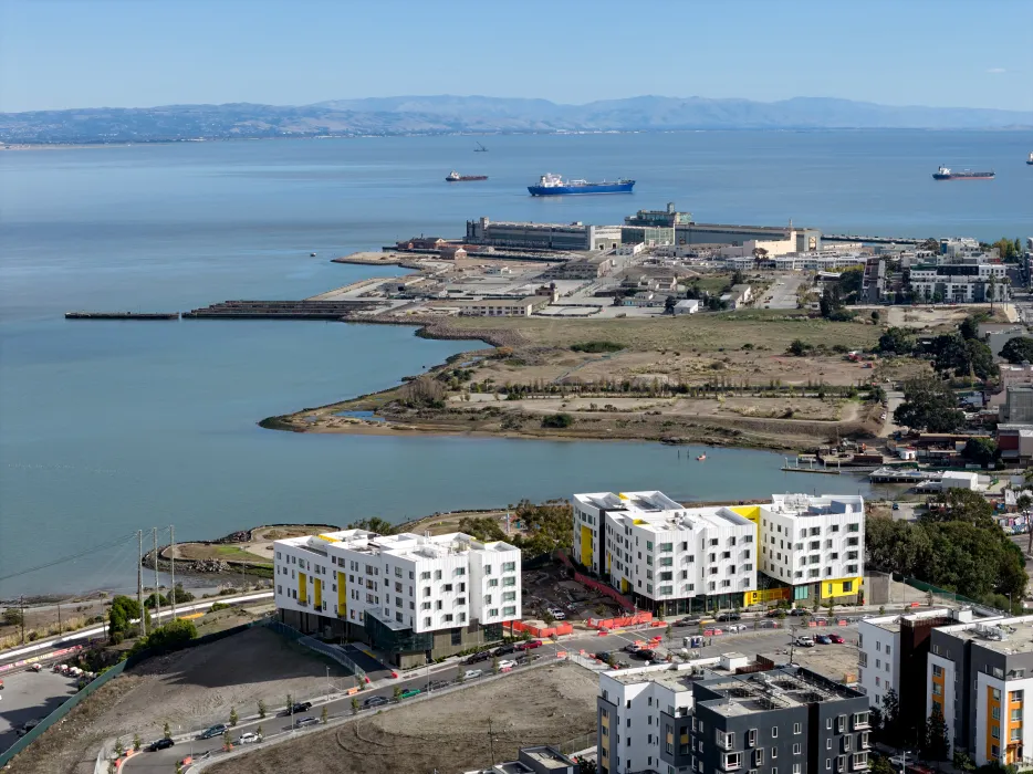 Aerial view shows the full three-phase development and water's edge