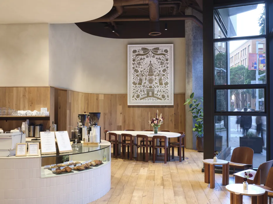 View of coffee shop with tables and window wall