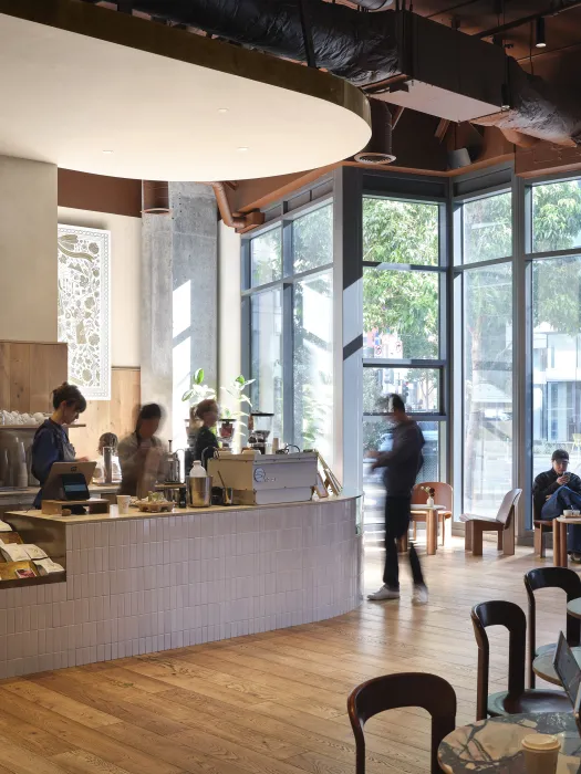 Coffee shop patrons enjoy the small, daylit shop