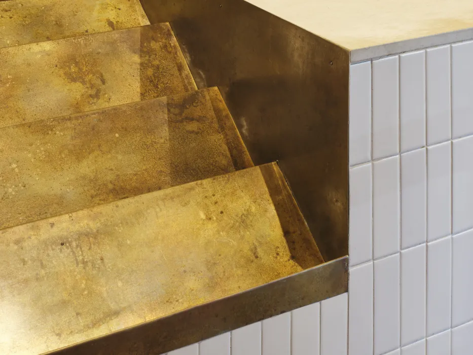 Detail of the cutout in the ordering counter: angled risers are build to hold bags of coffee beans and more