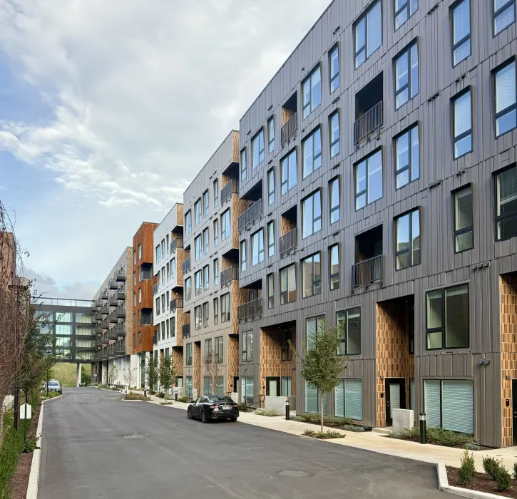 Large gray and rust building with crosswalk in background