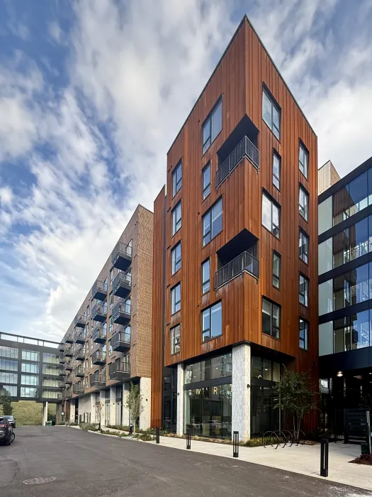 Rust colored corner building with crosswalk in background