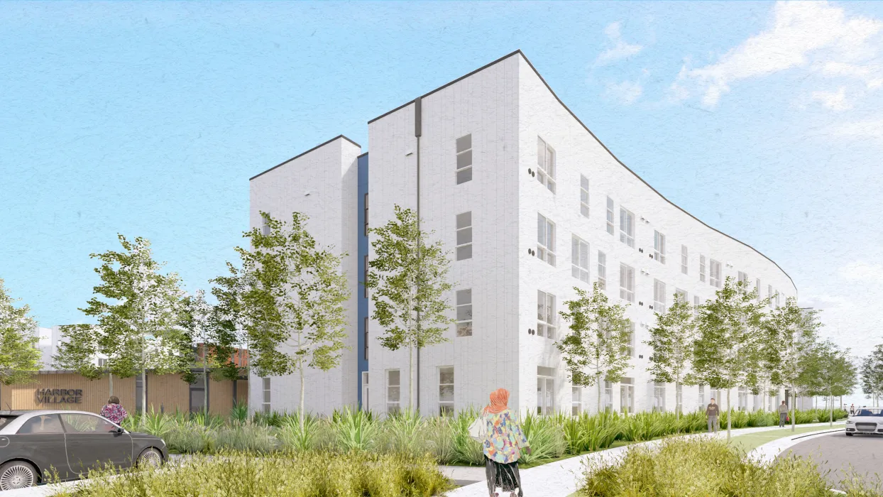 White building with blue and trees in foreground and blue sky background