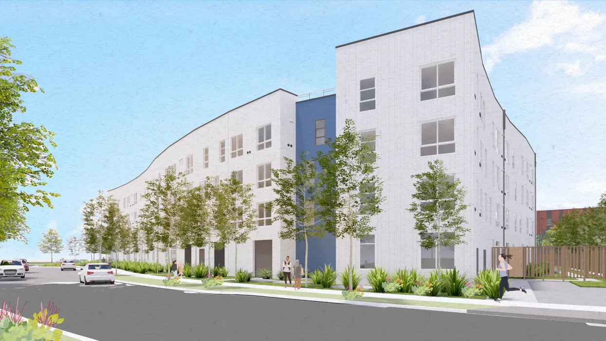 White building with blue and trees in foreground and blue sky background