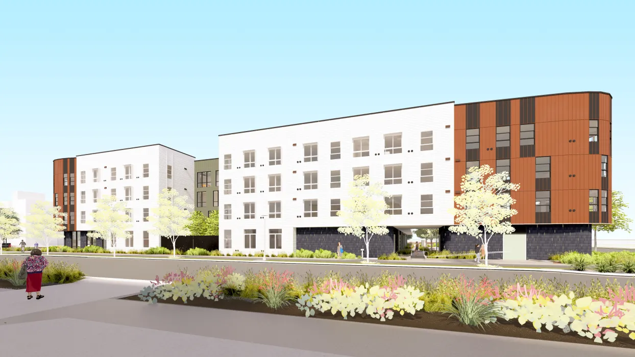 Rendering view of a long four-story building with a distinctive rounded massing at the right corner.