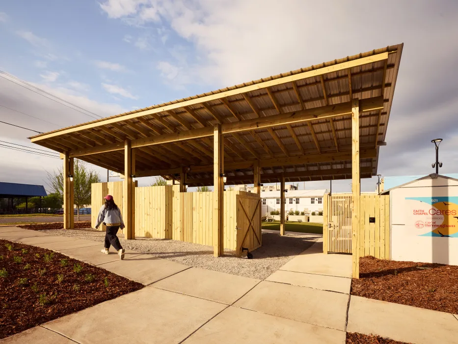 Front sidewalk and shade pavilion over an entry gate