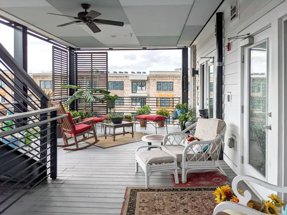 View of a covered porch with neatly arranged outdoor furniture