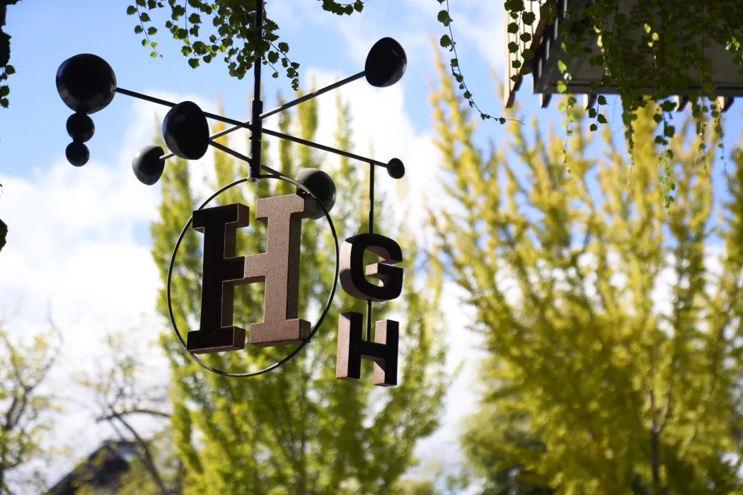 Detail of a hanging kinetic sculpture with the rotating letters H G and H