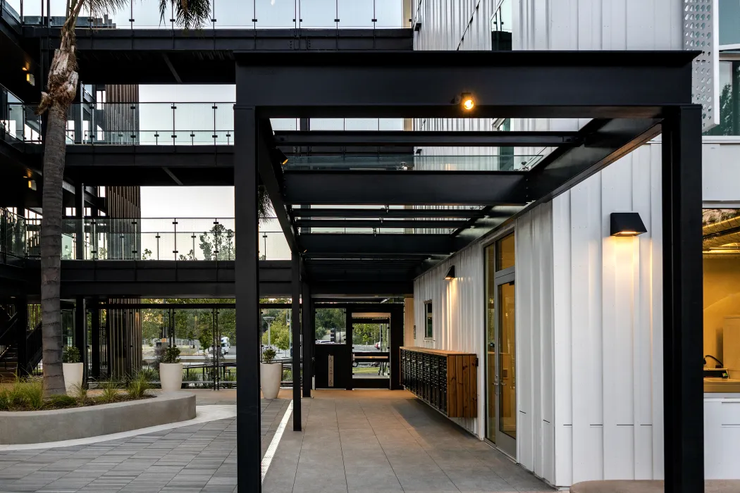 View from courtyard toward glass entry door of multfamily building